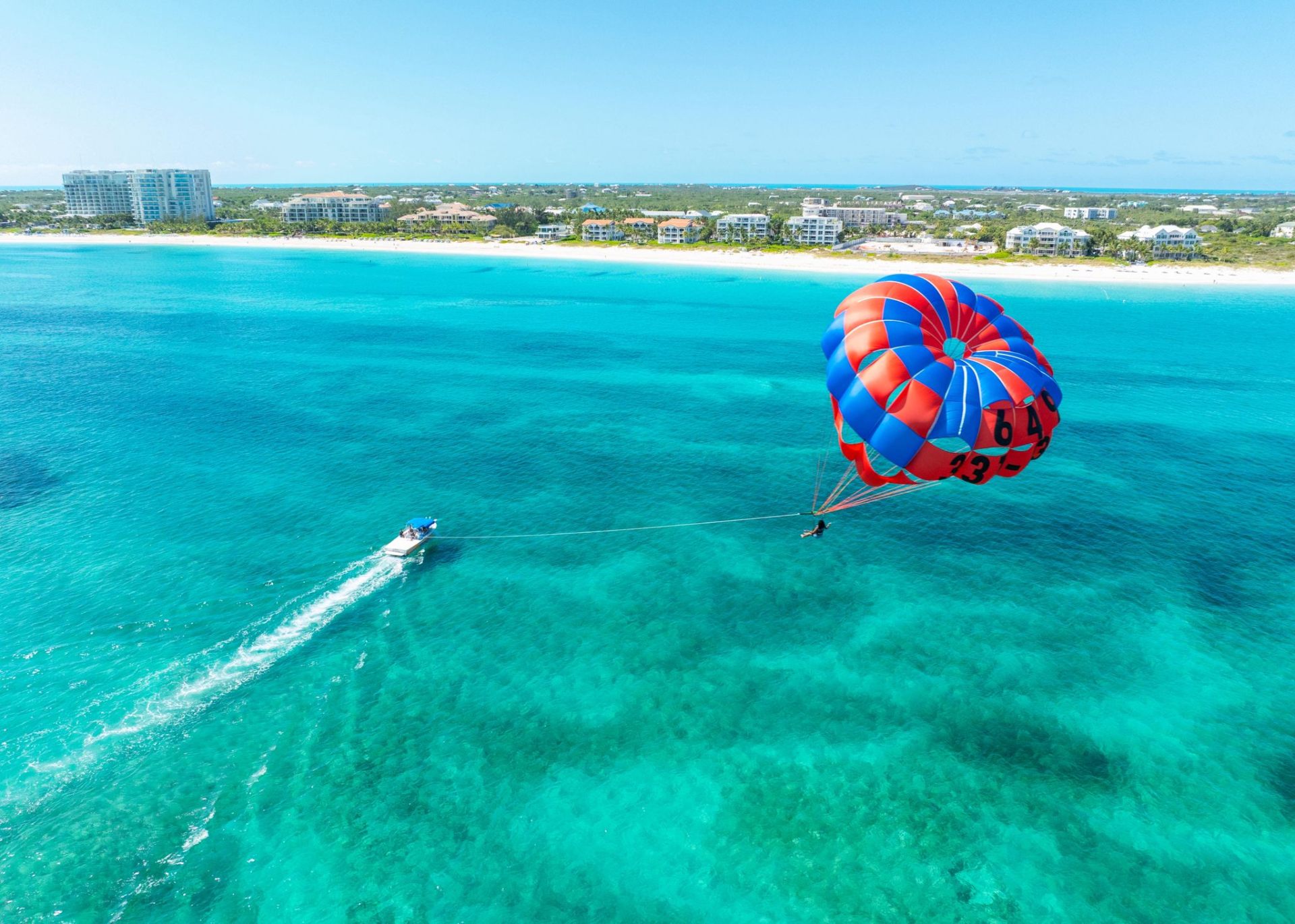 Aerial parasailing over turquoise water